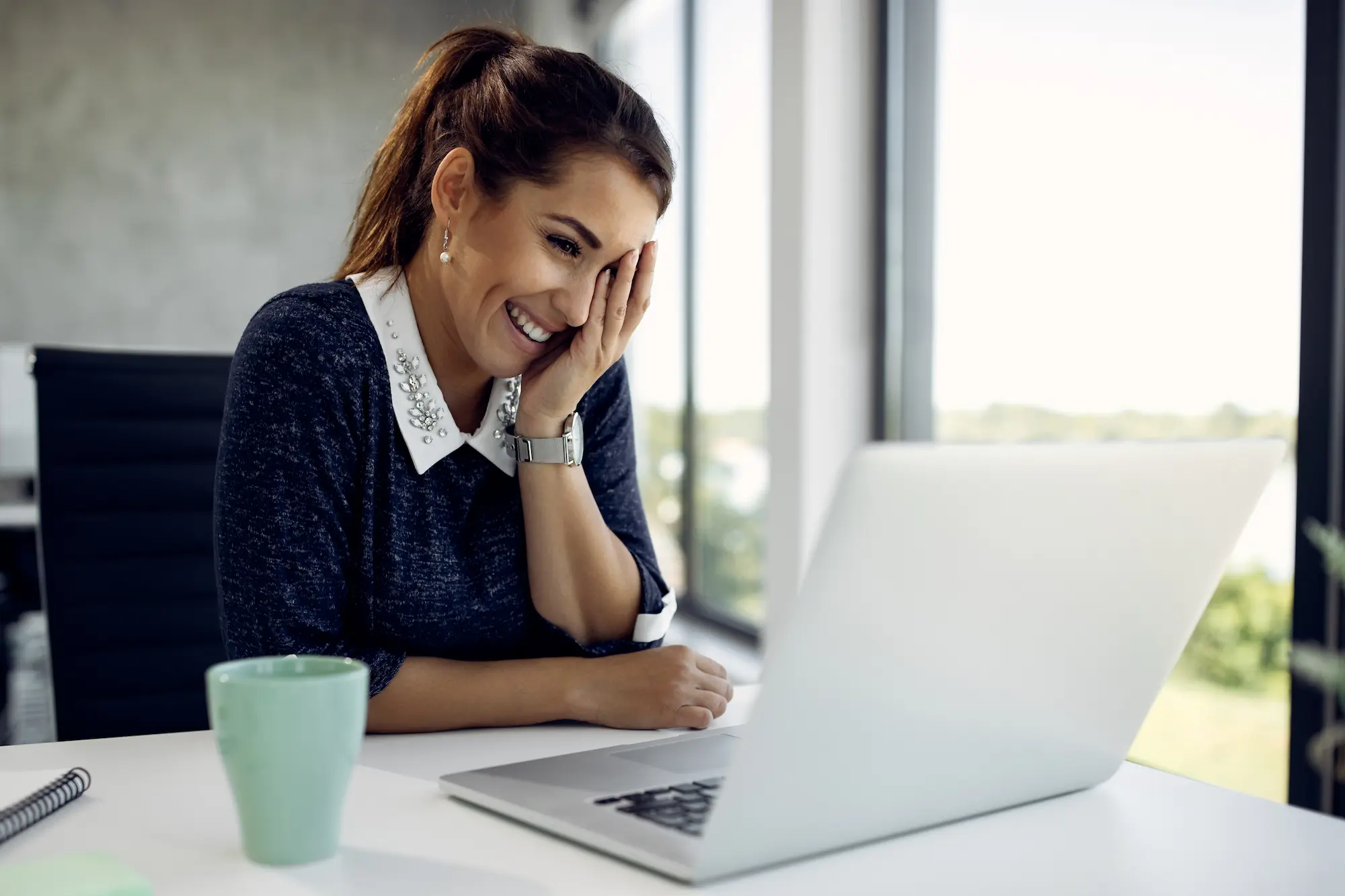 Franchise owner reviewing books on laptop
